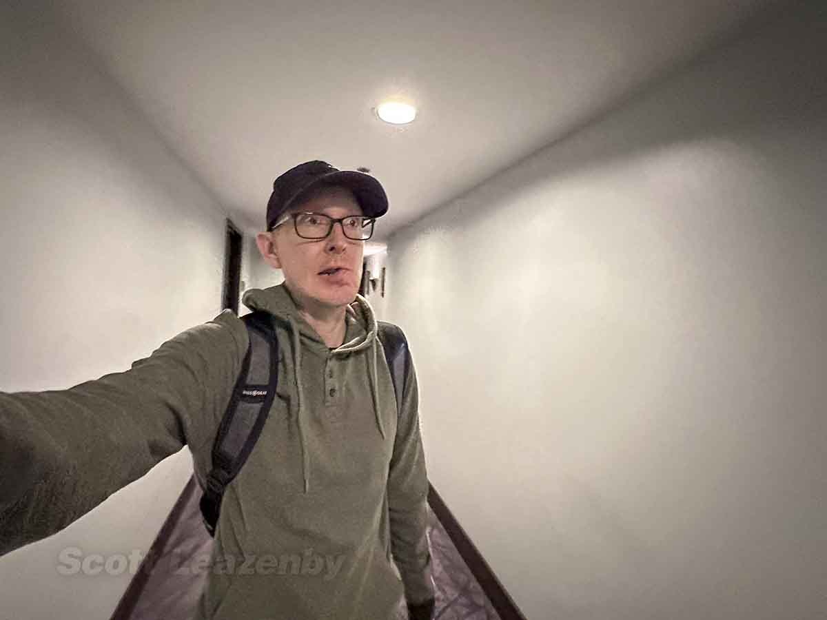 Scott walking through the 18th floor hallway W Hotel downtown Seattle