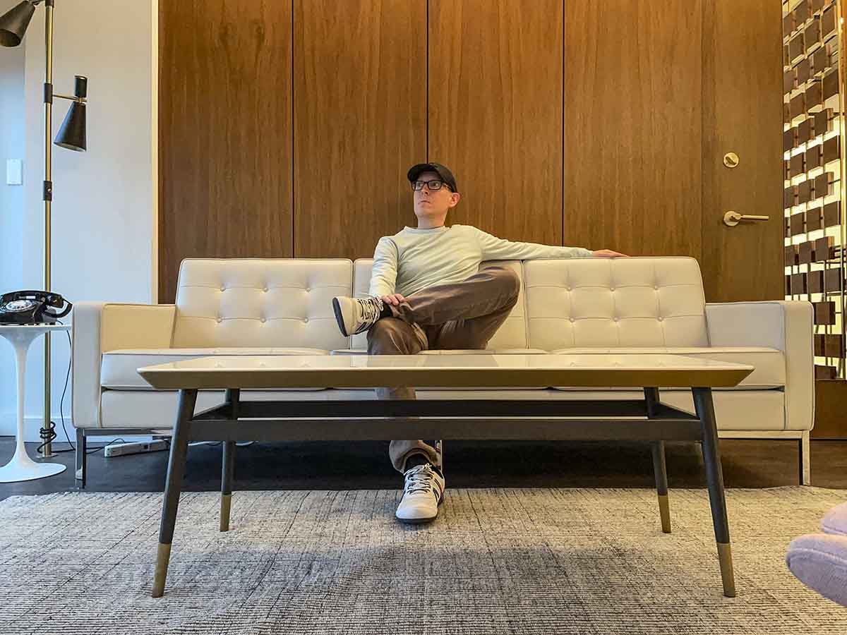 Scott Leazenby sitting on couch in TWA hotel Howard Hughes suite