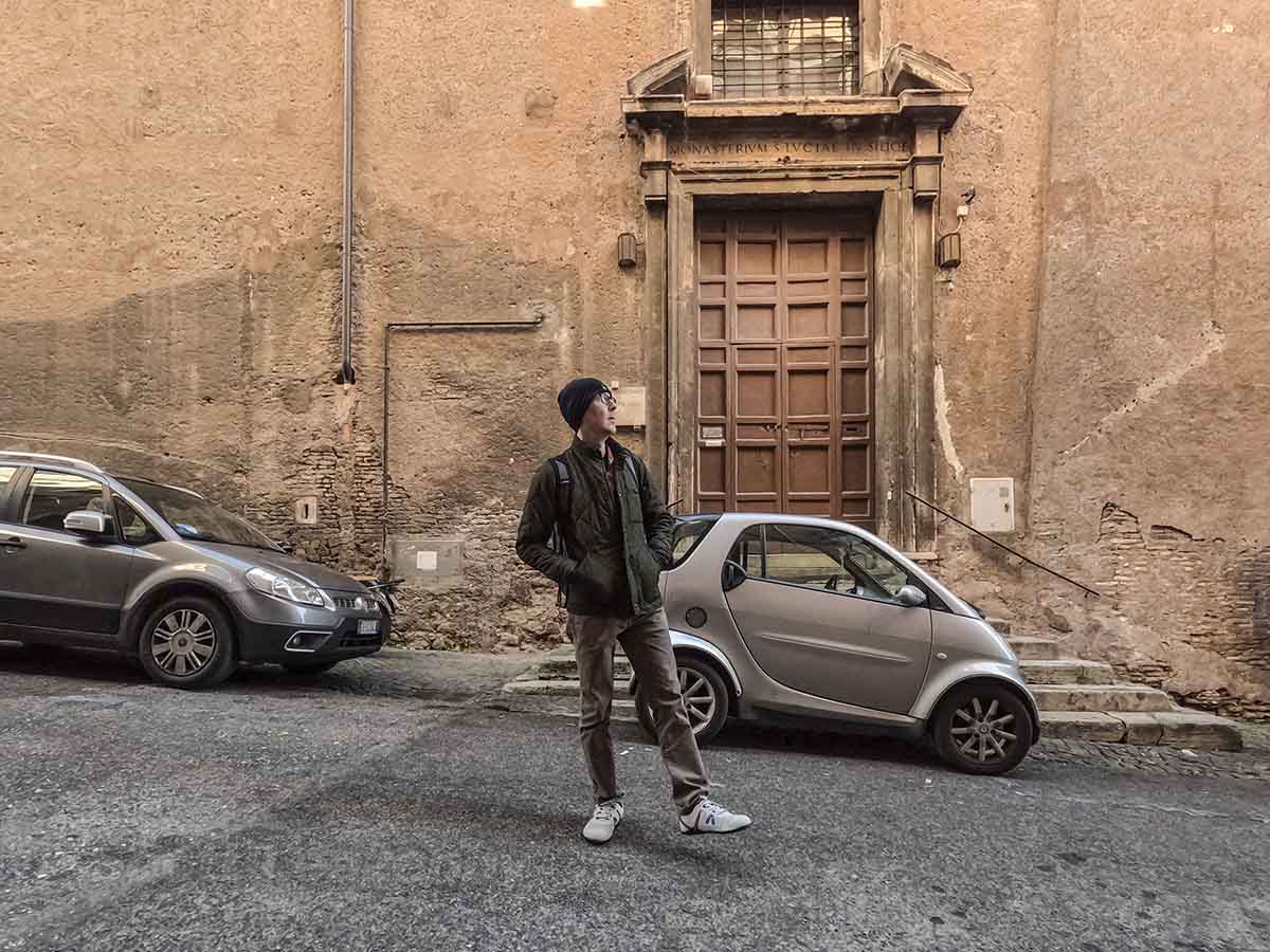 Scott walking down a residential street in Rome