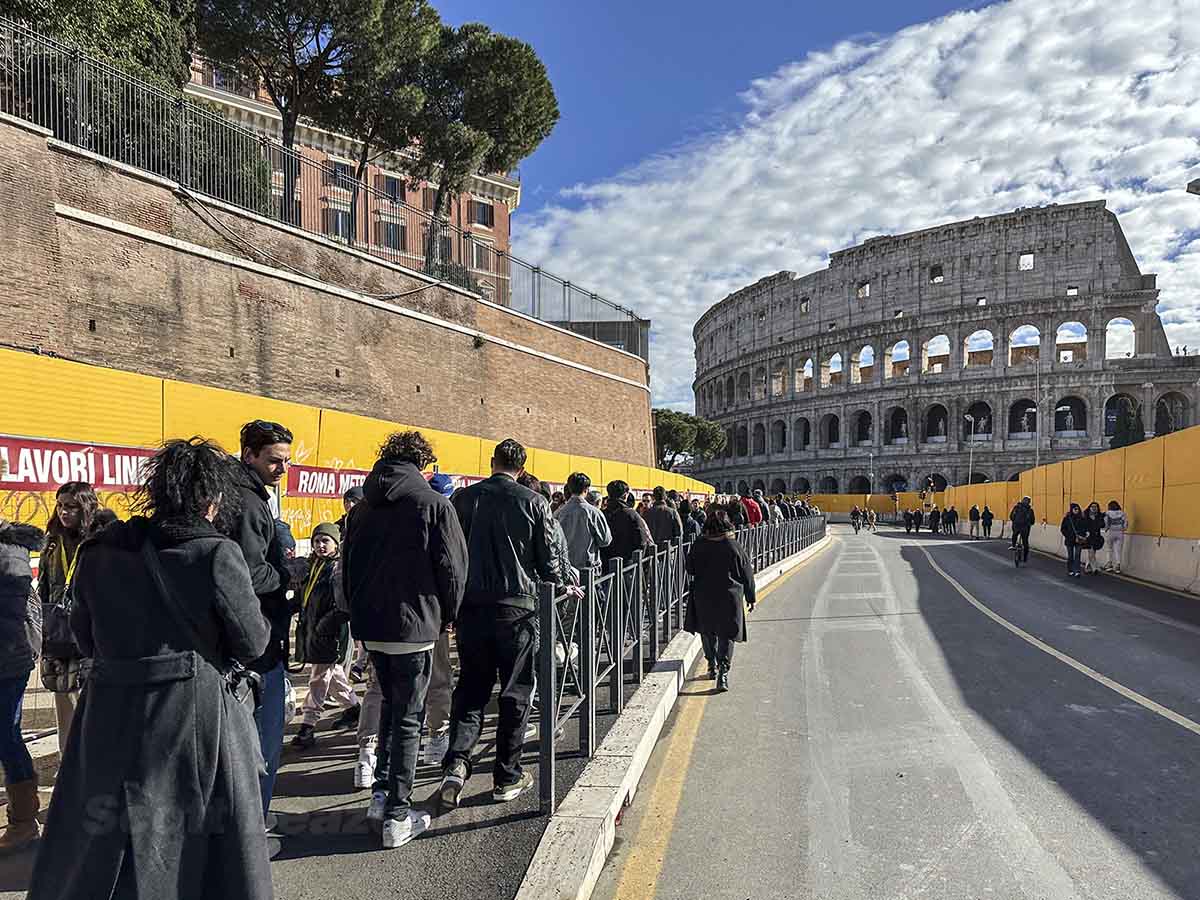 Tourists walking towards Colosseum in Rome