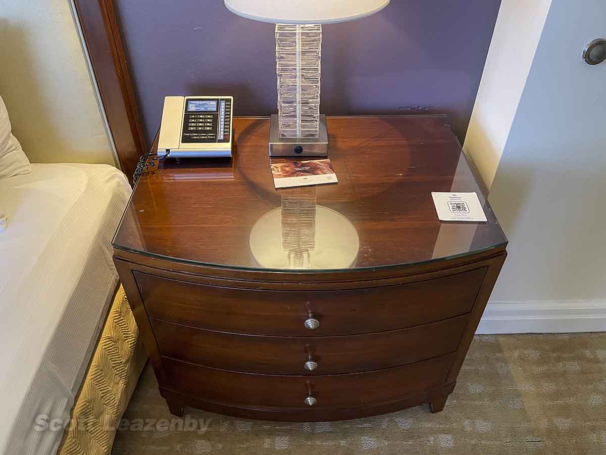 Bedside table with phone and lamp