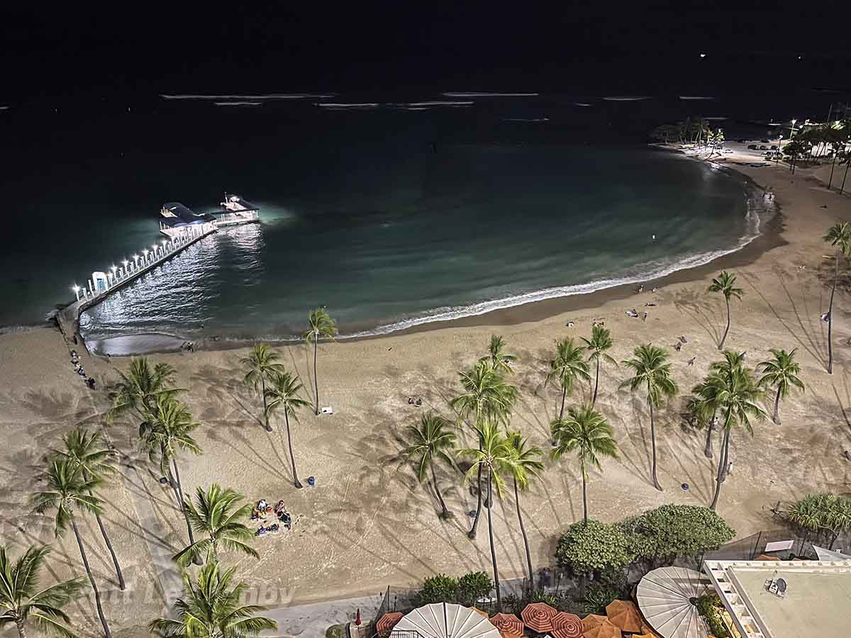 View of beach and pier at night