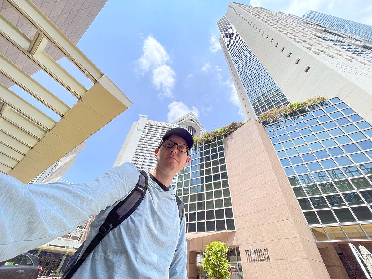 Scott standing next to the Pan Pacific Hotel in Singapore