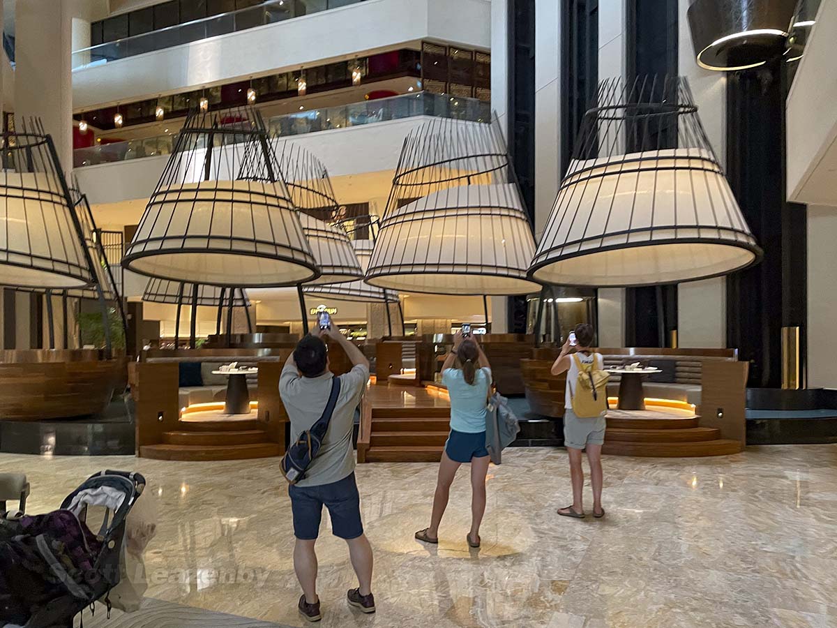 Tourists taking pictures inside the lobby of the pan Pacific Hotel in Singapore