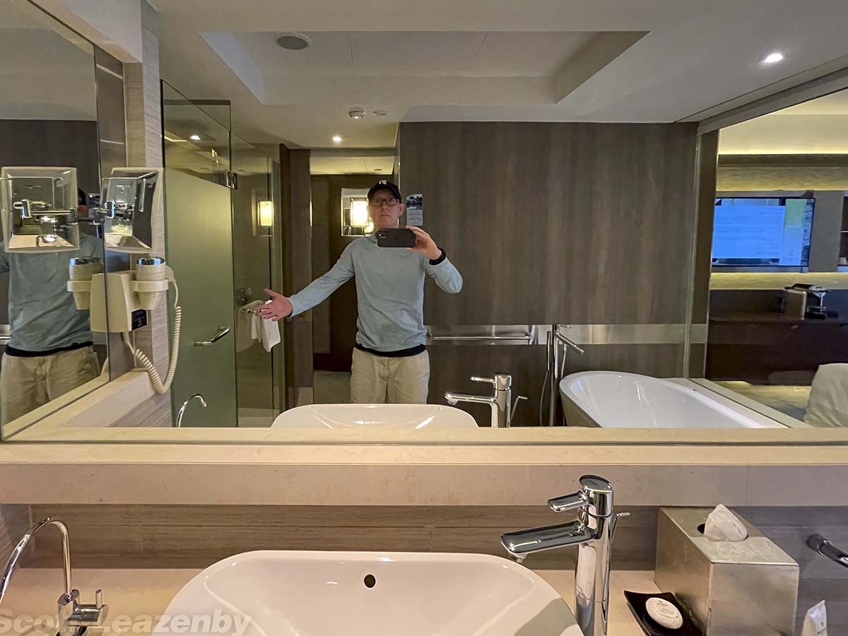 Scott standing in the bathroom at the pan Pacific Hotel in Singapore