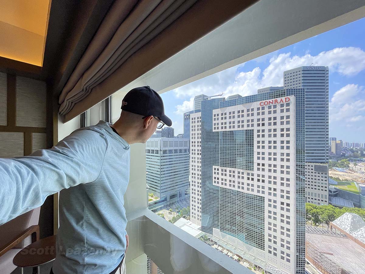 Scott looking out of the window at the pan Pacific Hotel Singapore